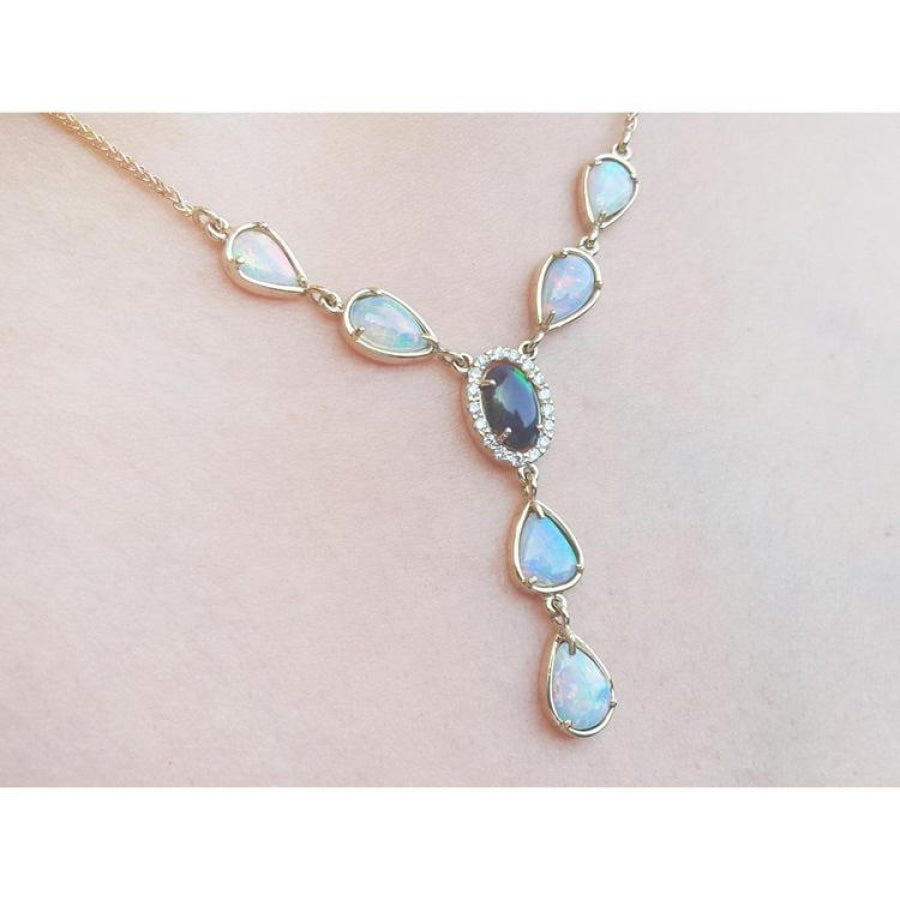 14k yellow gold Australian black opal and diamond halo necklace with teardrop opals.