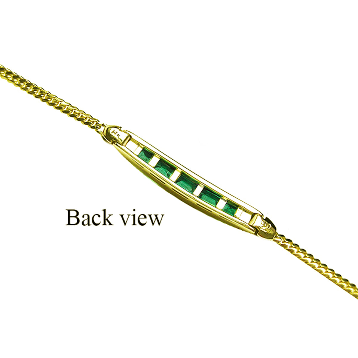 This backside view of a gold bracelet with emeralds on an underside position.