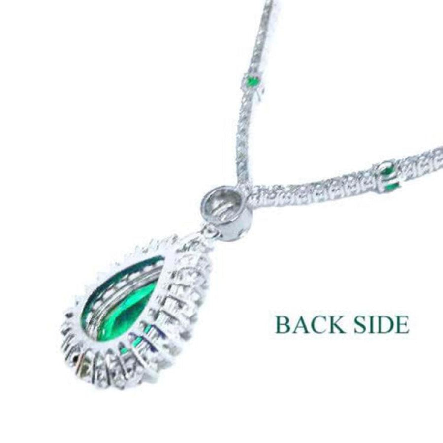 Back view of 18K white gold necklace with pear-cut emerald pendant and diamond halo.