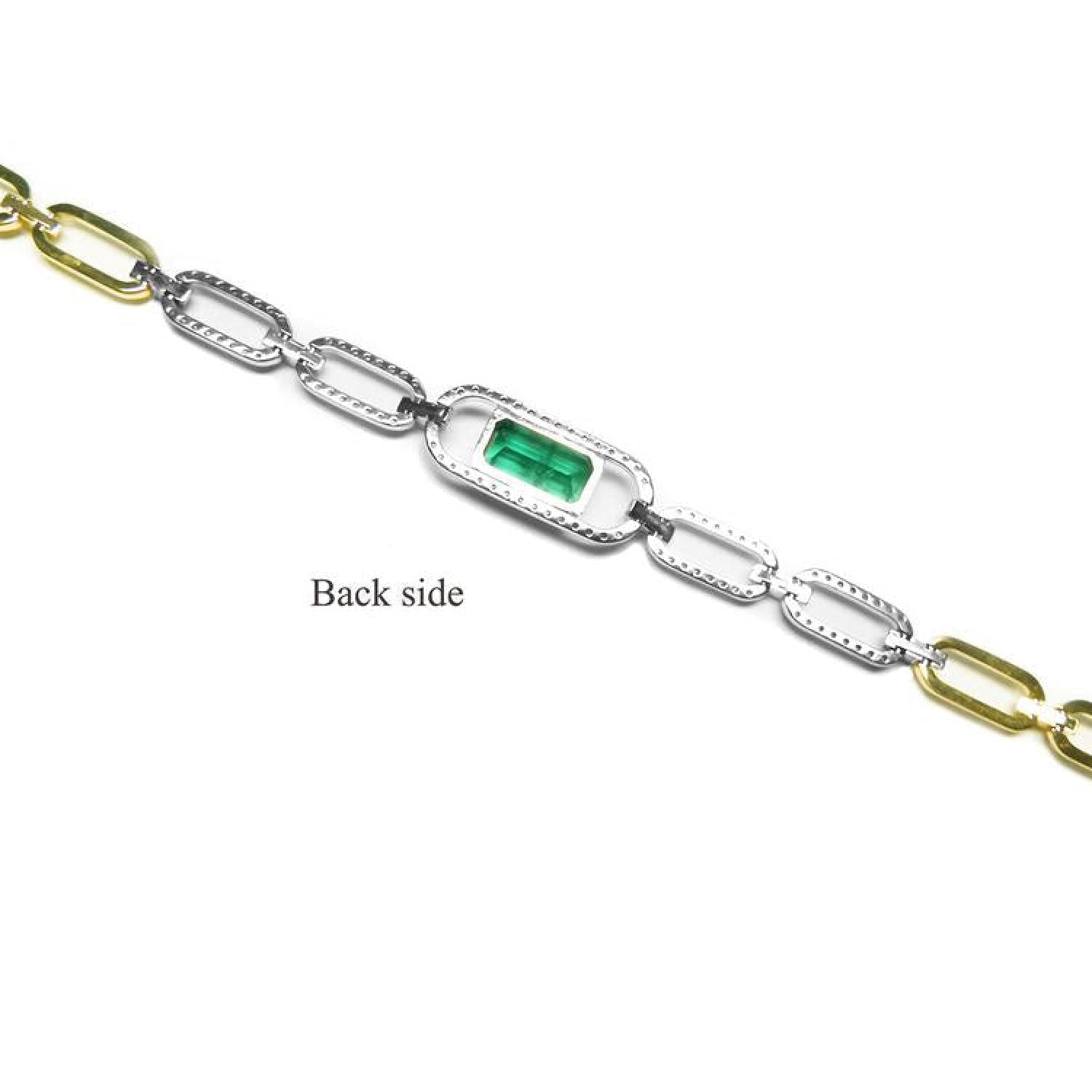 Back of 14K white and yellow gold paperclip bracelet with emerald-cut emerald.