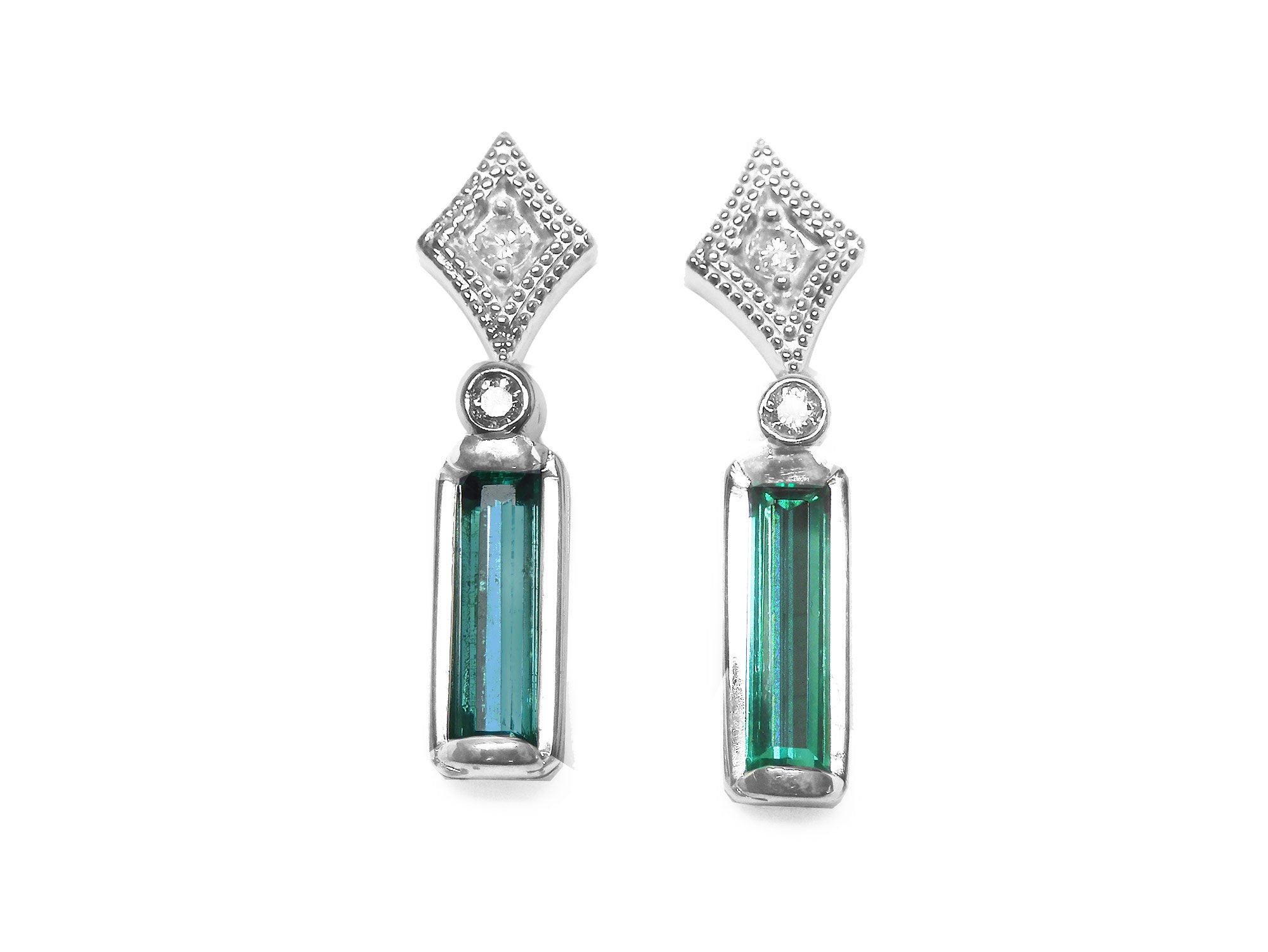 Pair of earrings with baguette natural emeralds and diamond tops on a front side top view position