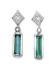 Pair of earrings with baguette natural emeralds and diamond tops on a front side top view position