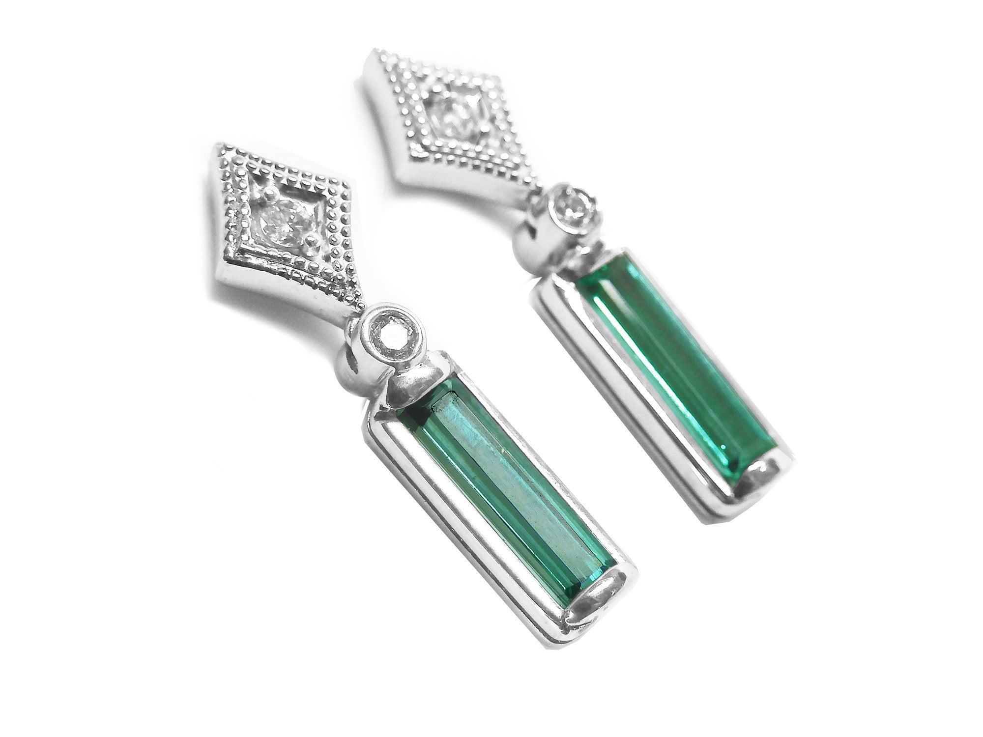 14k white gold baguette cut emerald earrings with accent diamonds on a right-side profile gallery view