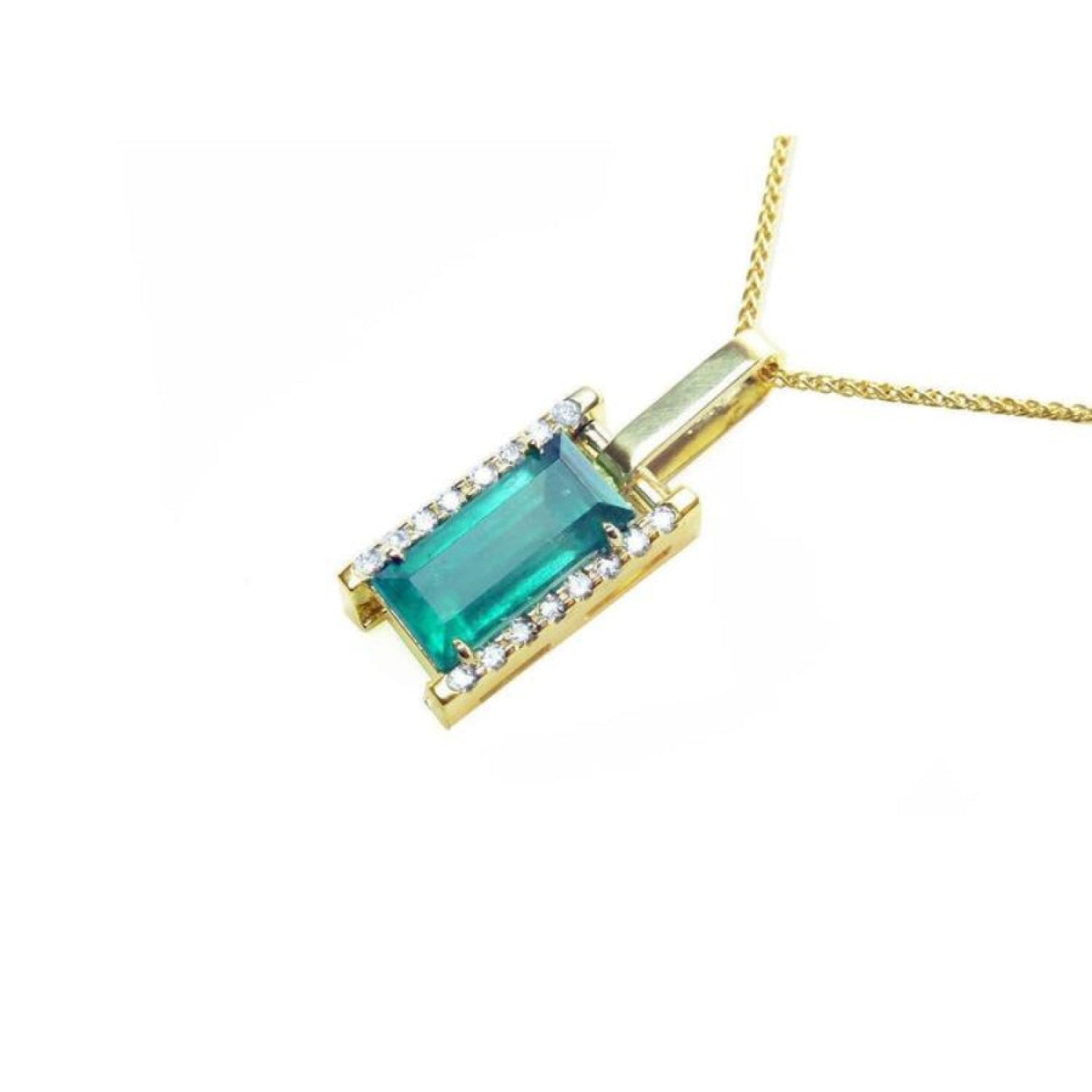 Baguette cut Colombian emerald pendant in 18K yellow gold with diamond accents on a delicate chain.