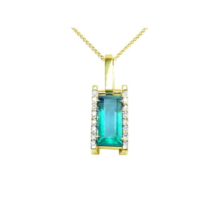 Gold pendant with a emerald baguette cut on a front position topside view.