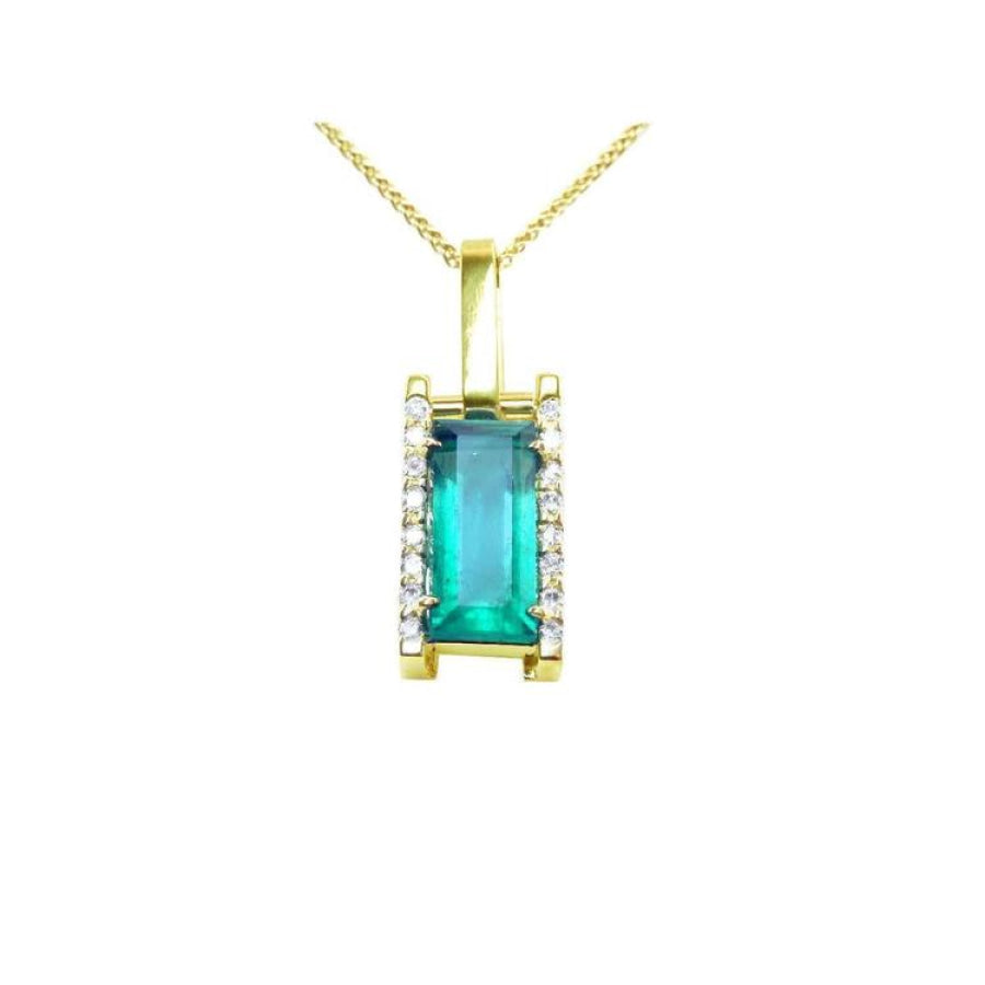 Baguette cut Colombian emerald pendant in 18K yellow gold with diamond accents.