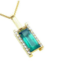 A 18k yellow gold baguette cut natural colombian emerald pendant with diamond accents.