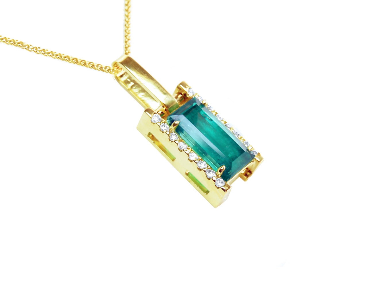 The right side profile view of a yellow gold emerald baguette pendant.