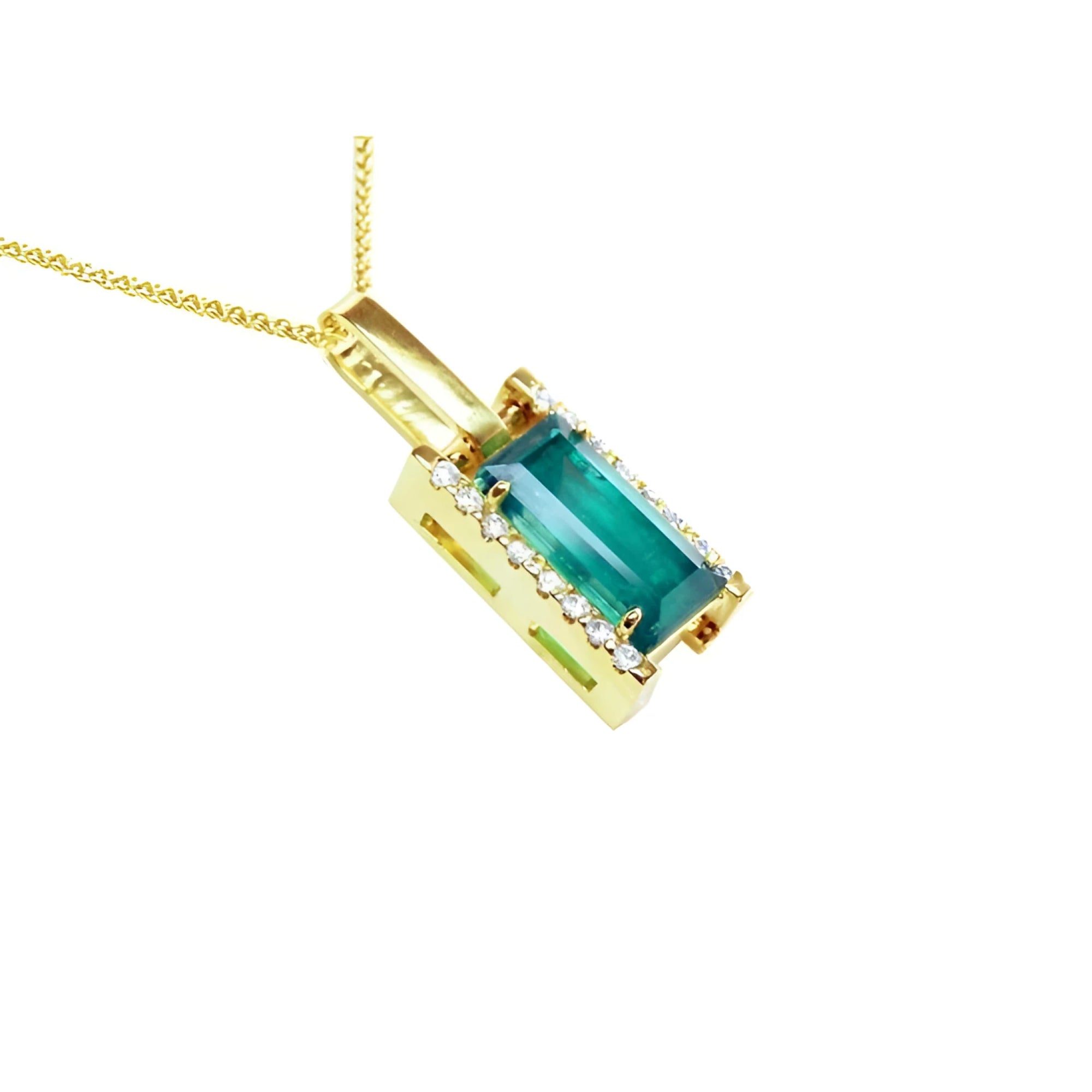 Baguette cut Colombian emerald pendant in 18K yellow gold with diamond accents on a delicate chain.