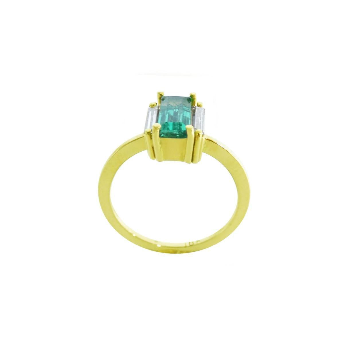 Baguette cut emerald and diamond ring in 18k yellow gold, side top, gallery and band profile view.