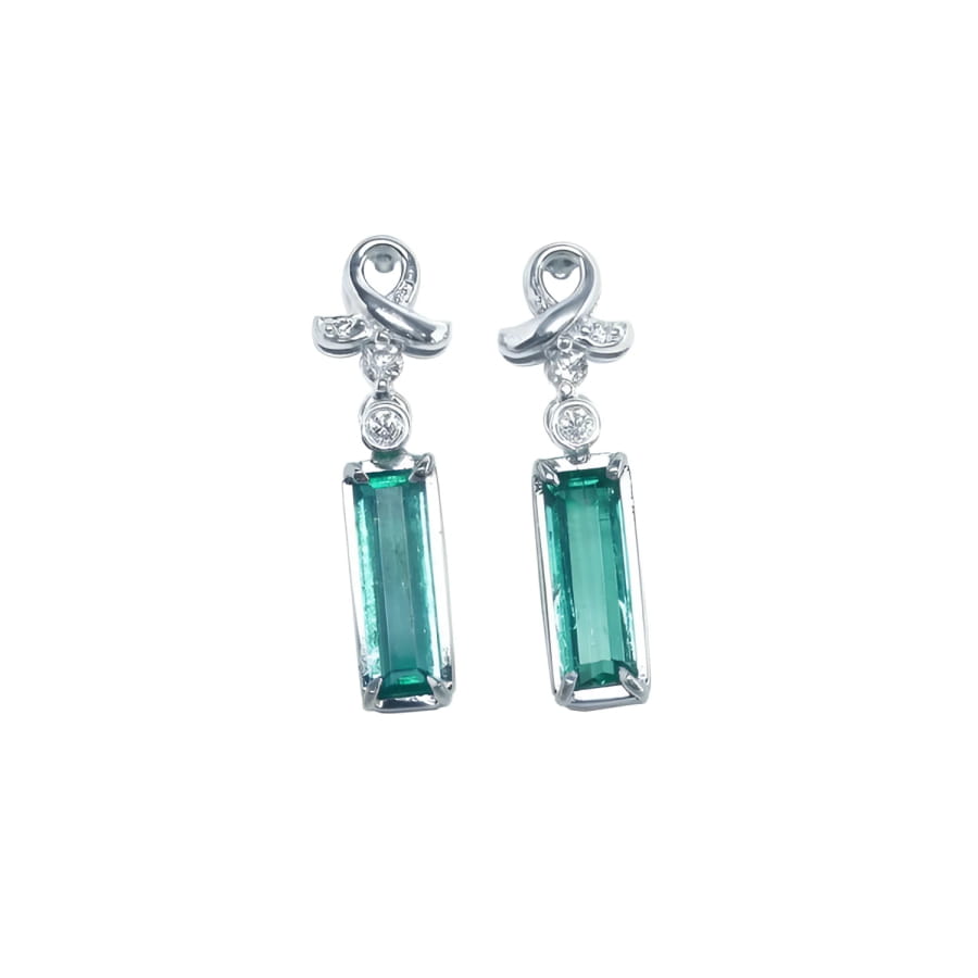 Emerald-cut natural emerald earrings in 14k white gold with diamond ribbon design.