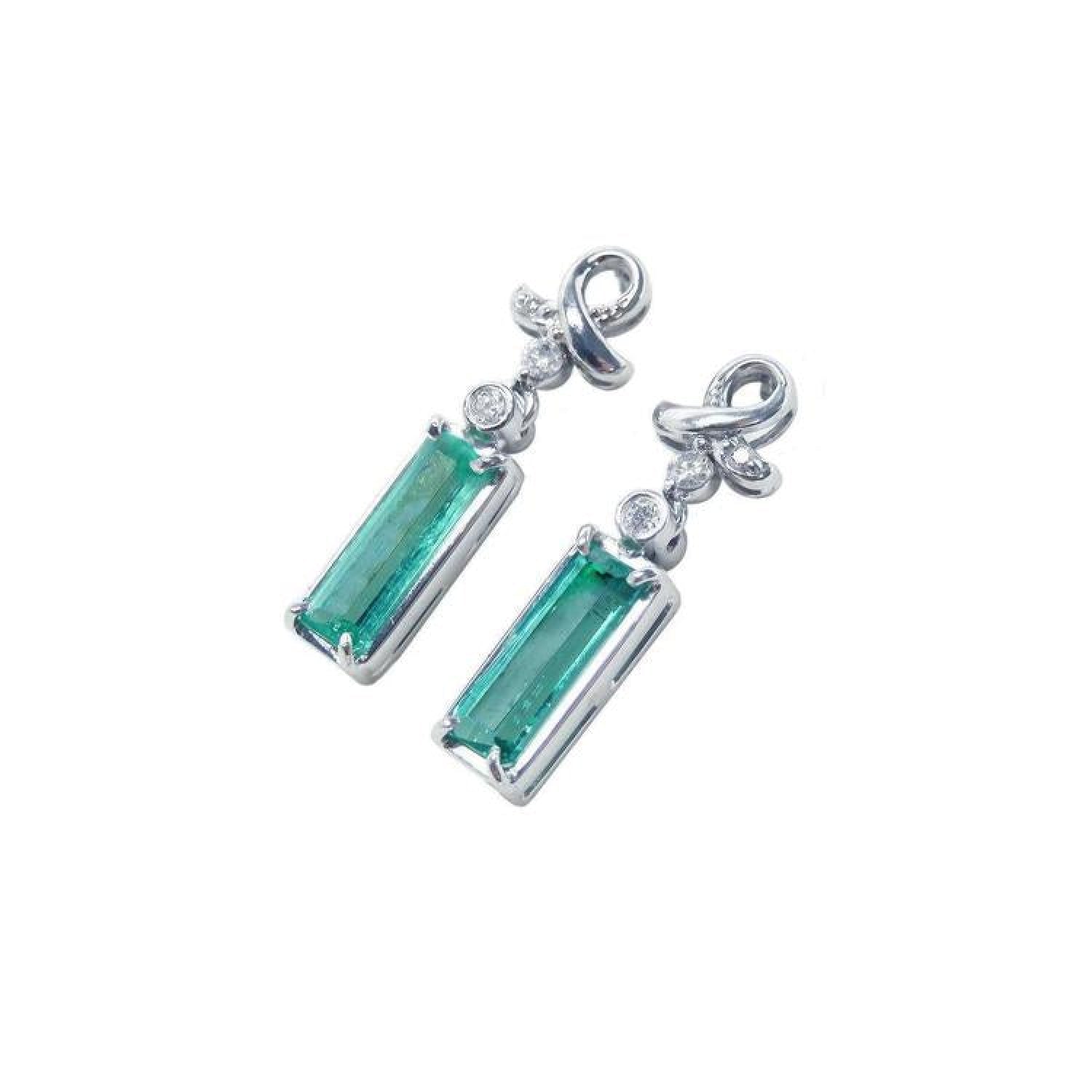 Emerald-cut natural emerald earrings in 14k white gold with ribbon design and accent diamonds.