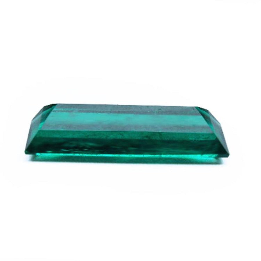 3.13 carat baguette cut Colombian emerald with sparkling bluish-green color.