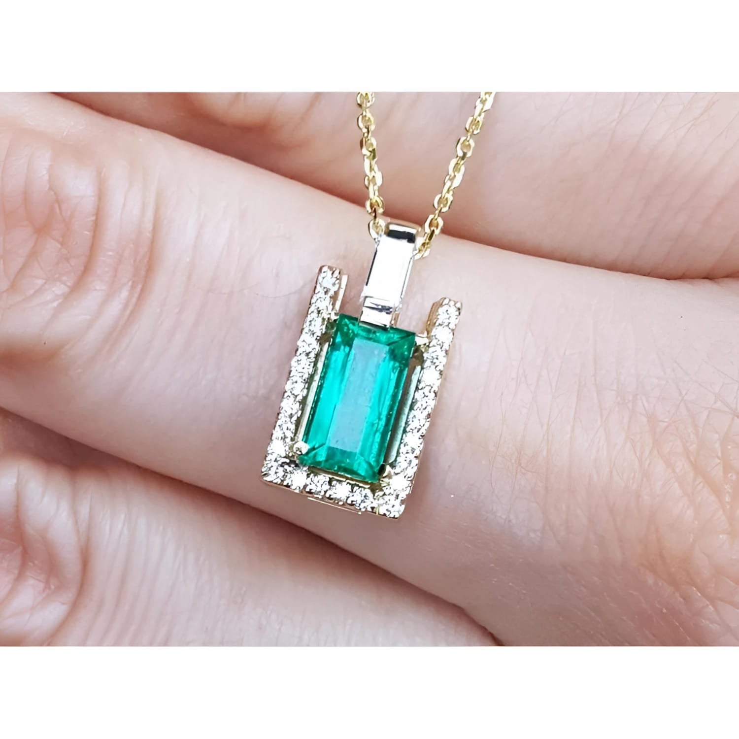 Baguette cut emerald pendant necklace with natural diamonds in 14K yellow gold.