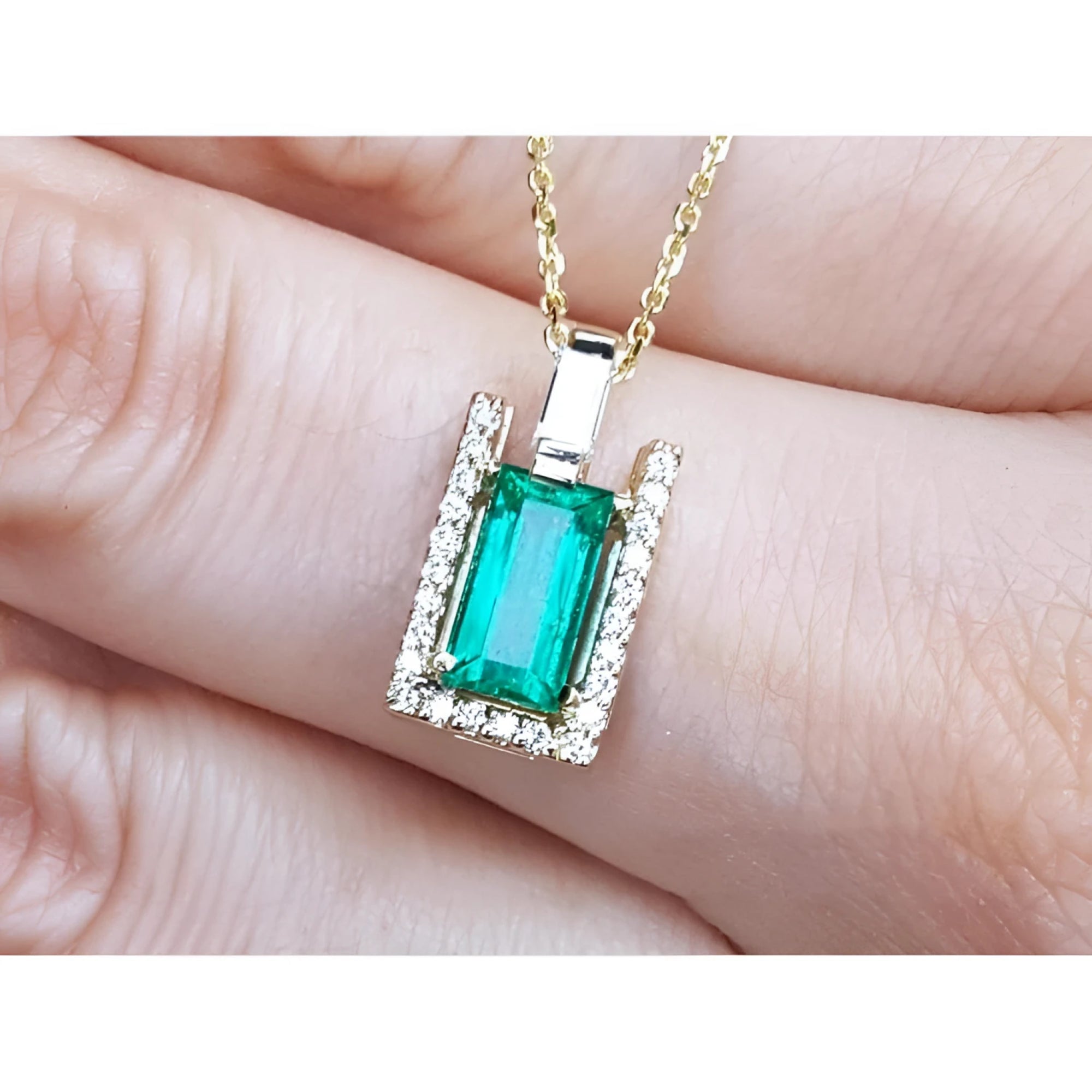 Baguette cut emerald pendant necklace with natural diamonds in 14K yellow gold.