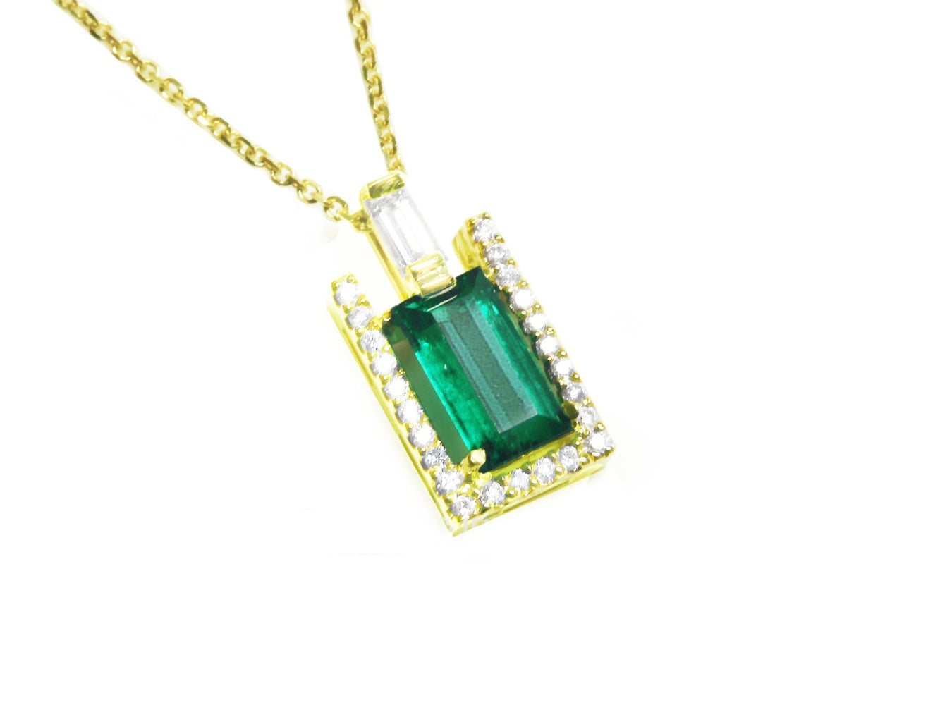 This yellow gold emerald baguette pendant displays the topside on a right side position.