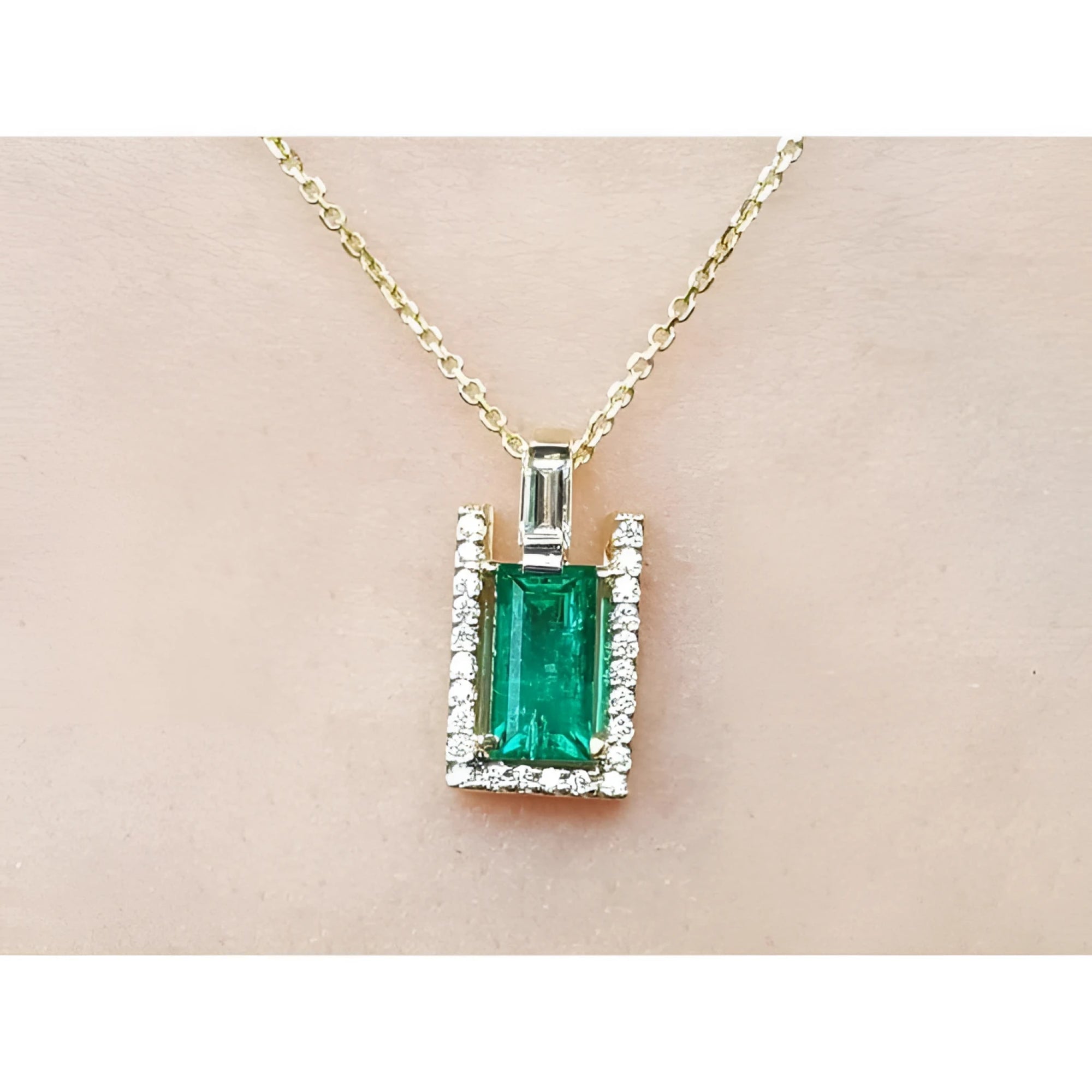 1.14 ct baguette emerald pendant necklace with natural diamonds on a 14K yellow gold chain.
