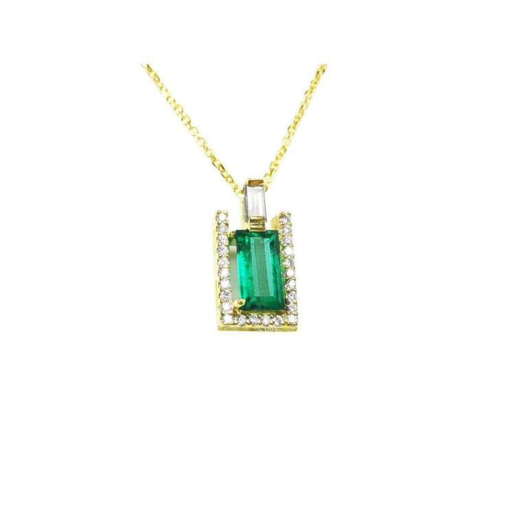 The topside view of a natural emerald baguette cut surrounded of diamonds pendant on a yellow gold chain.