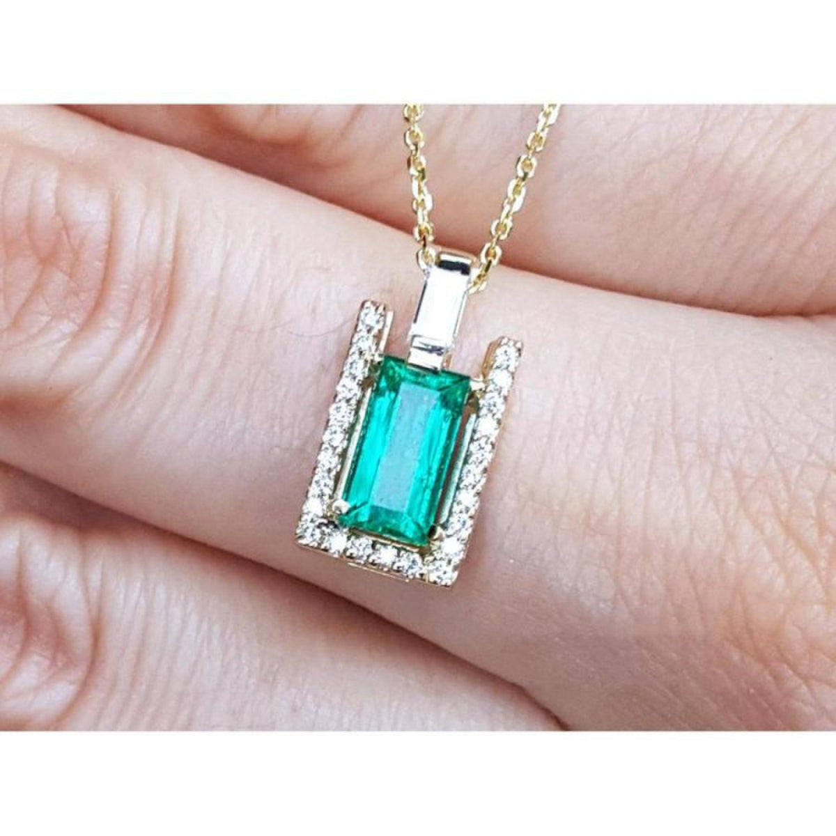 Baguette cut emerald pendant necklace with natural diamonds in 14K yellow gold.