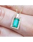 Baguette cut emerald pendant necklace with natural diamonds in 14K yellow gold.