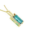 5.15 ct. baguette-cut Colombian emerald pendant in 18K yellow gold with diamond accents.