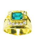 This men's emerald bezel set ring in yellow gold with accent diamonds displays its top and sides profile.