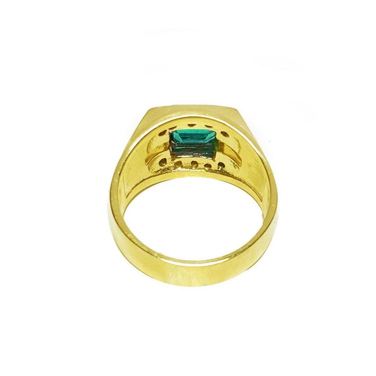 The underside view of a men's emerald ring in yellow gold.