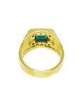 The underside view of a men's emerald ring in yellow gold.