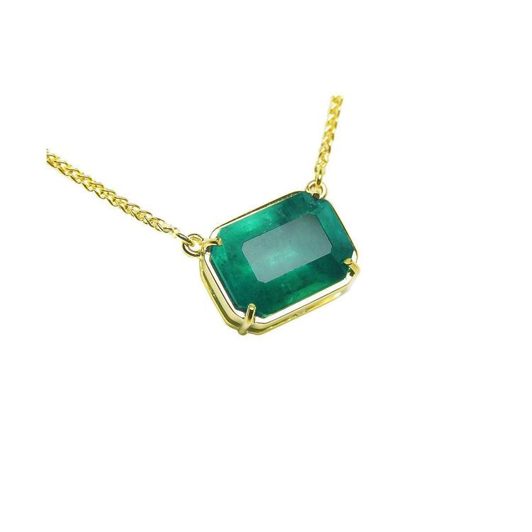 Women's Solitaire Emerald necklace sourced from the Muzo mine, set in a handcrafted 18k yellow gold frame