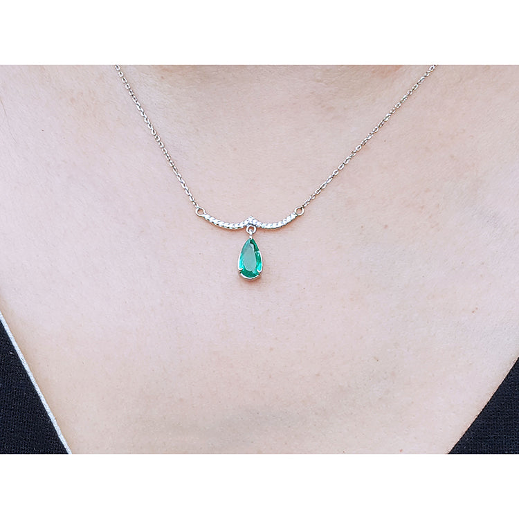 May&#39;s birthstone necklace natural Colombian emerald dangling from a wavy central bar with diamonds pave set in 14k white gold