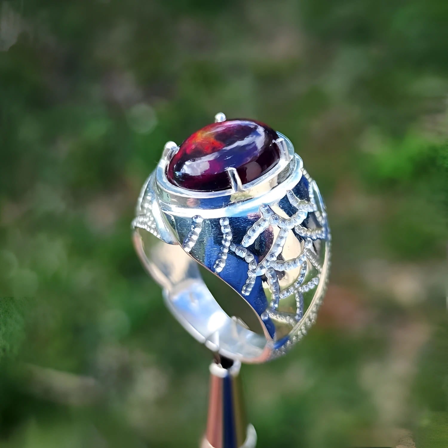 Men's 925 sterling silver ring with a striking black Ethiopian opal, showing red-orange and blue hues.