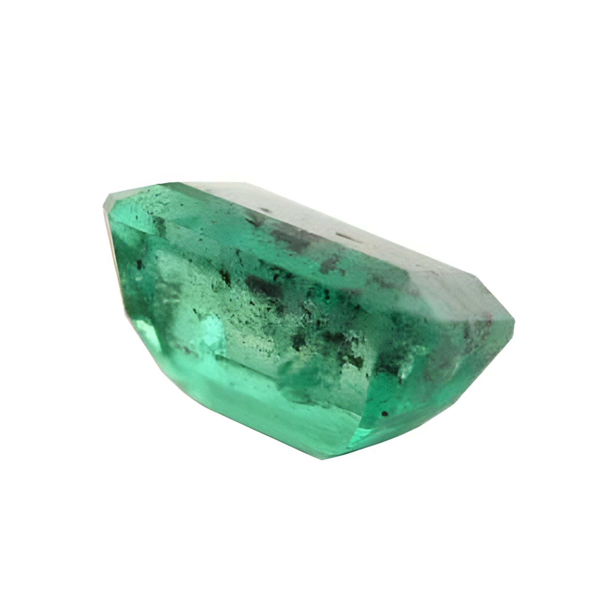 A heavy included emerald with black carbon spots.