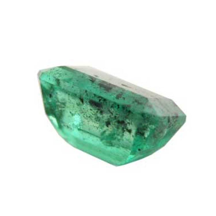 A heavy included emerald with black carbon spots.