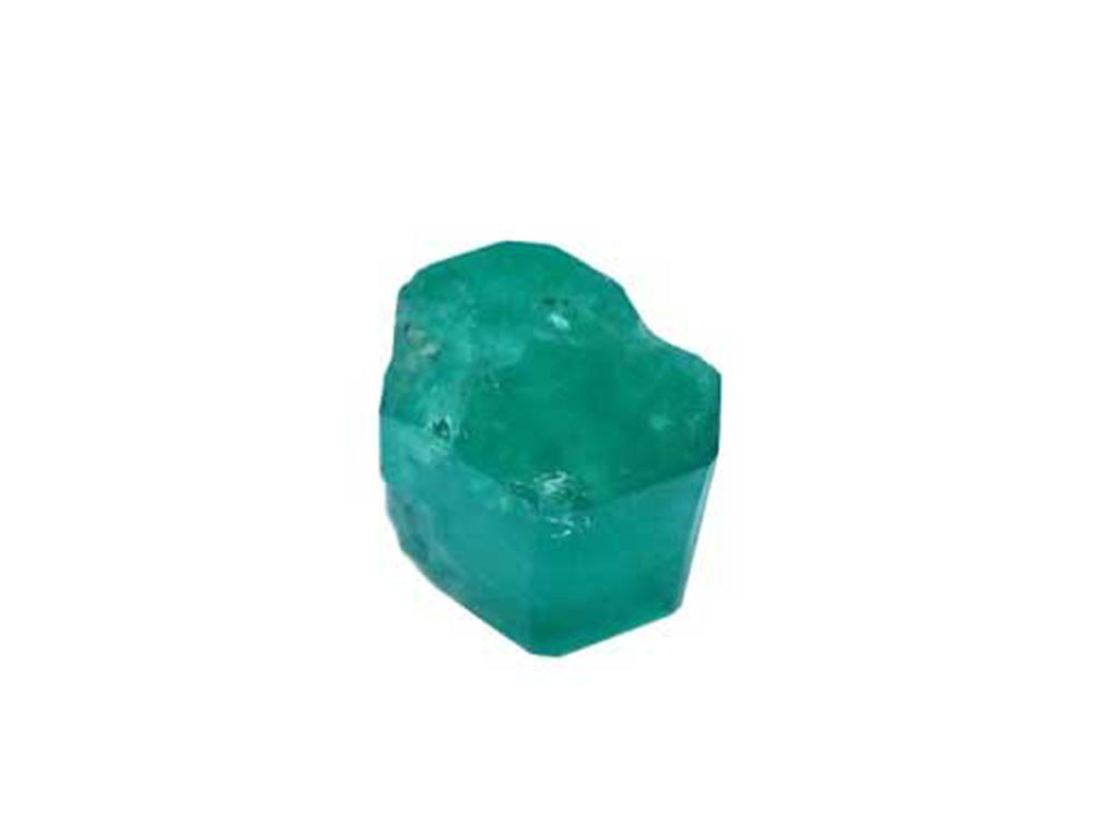 Showing the cylindrical shape, the natural formation of a rough emerald ready to be cut