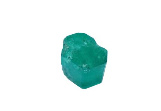 Showing the cylindrical shape, the natural formation of a rough emerald ready to be cut