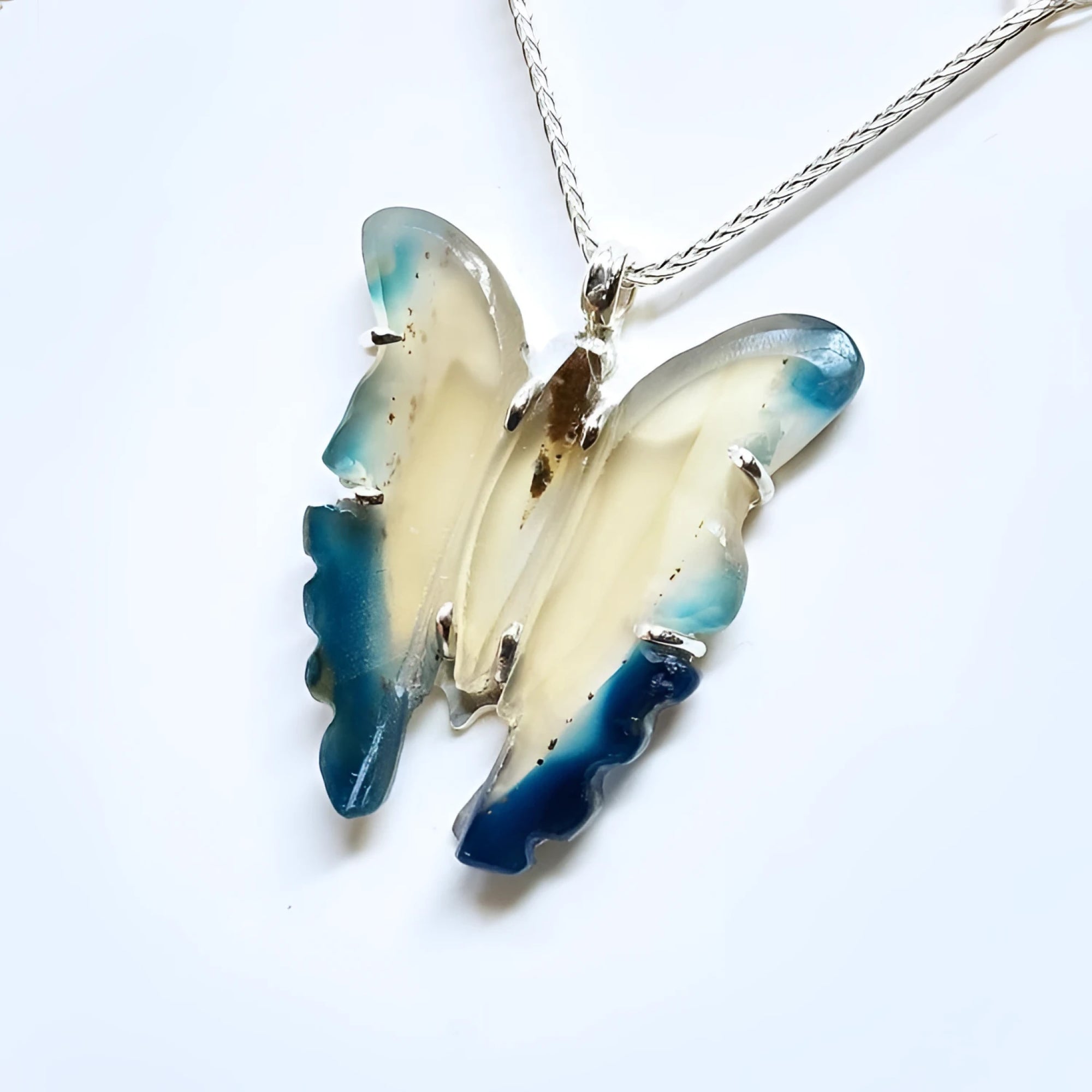 Hand-carved natural blue agate butterfly pendant necklace with sterling silver chain.