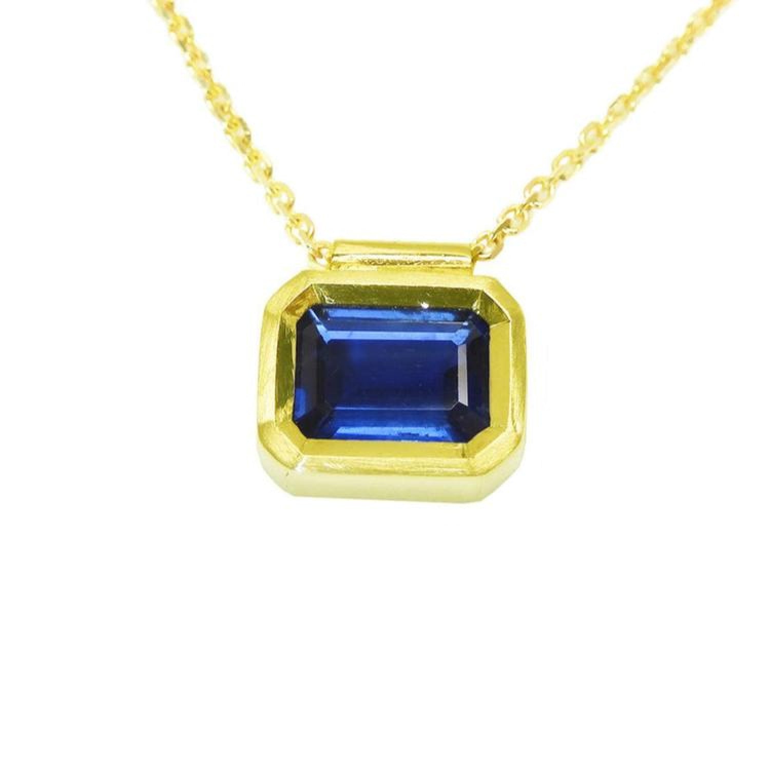 1.01 ct medium-dark blue sapphire choker, bezel set in 14K gold on a cable chain.