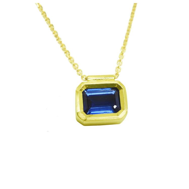 Front position top view of a blue sapphire choker necklace solitaire slider bezel set crafted in 14k yellow gold