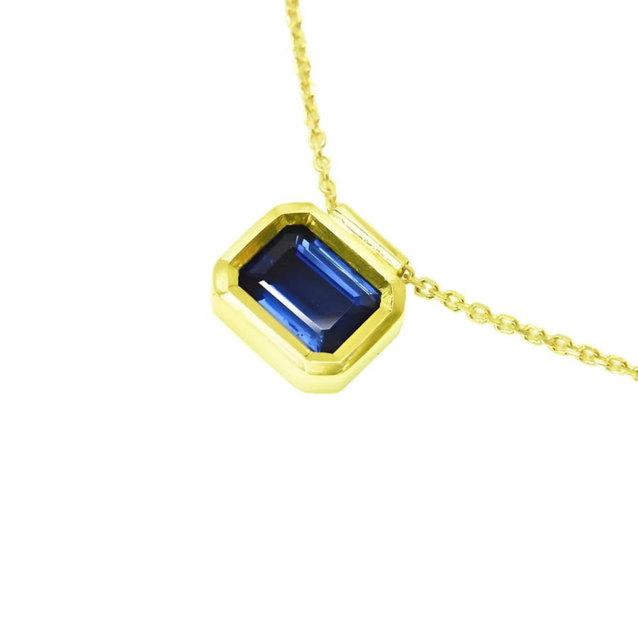 1.01 ct blue sapphire choker in a bezel setting on a 14K gold cable chain.