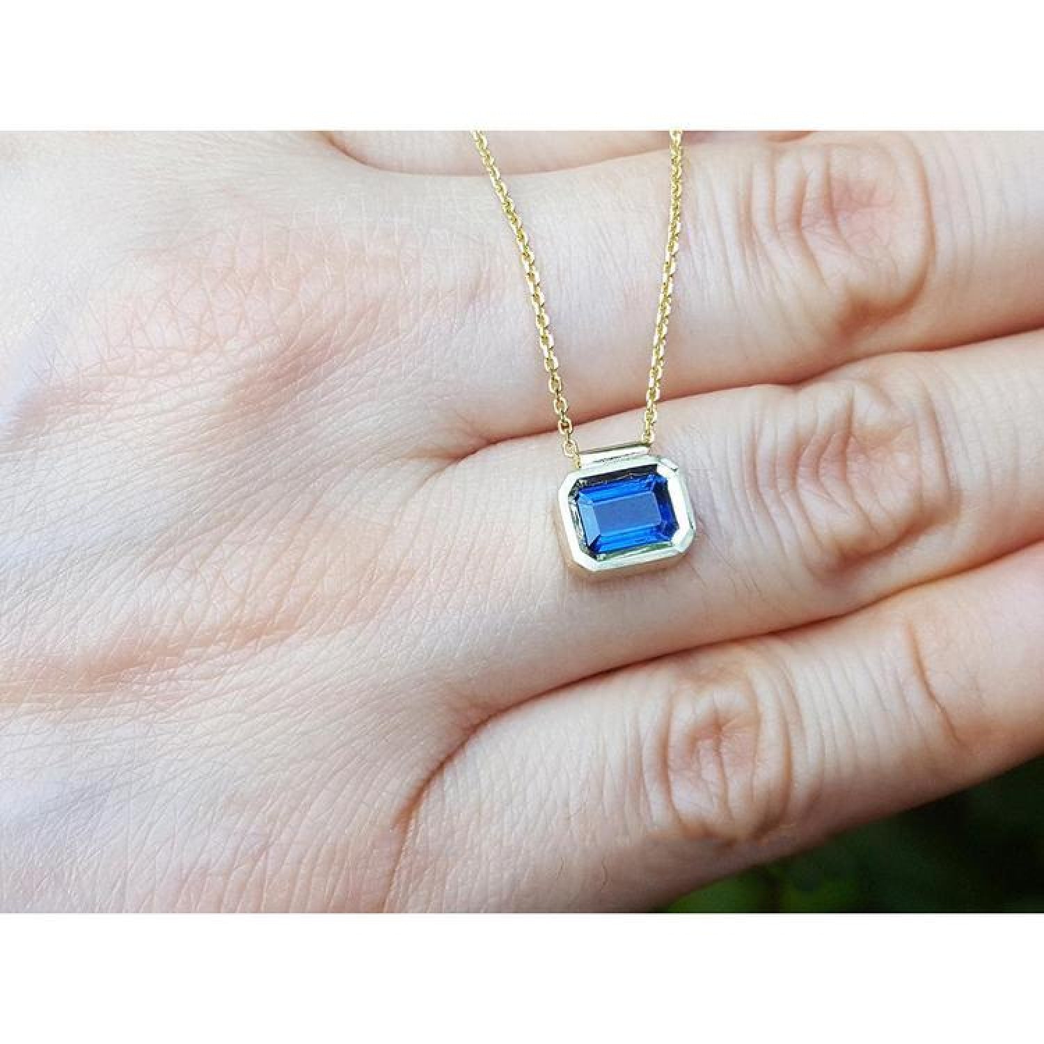 1.01 ct blue sapphire choker necklace, bezel set in 14K gold on a cable chain.