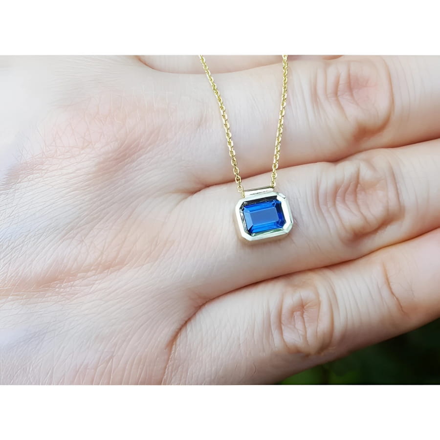 1.01 ct blue sapphire choker necklace, bezel set in 14K gold on a cable chain.