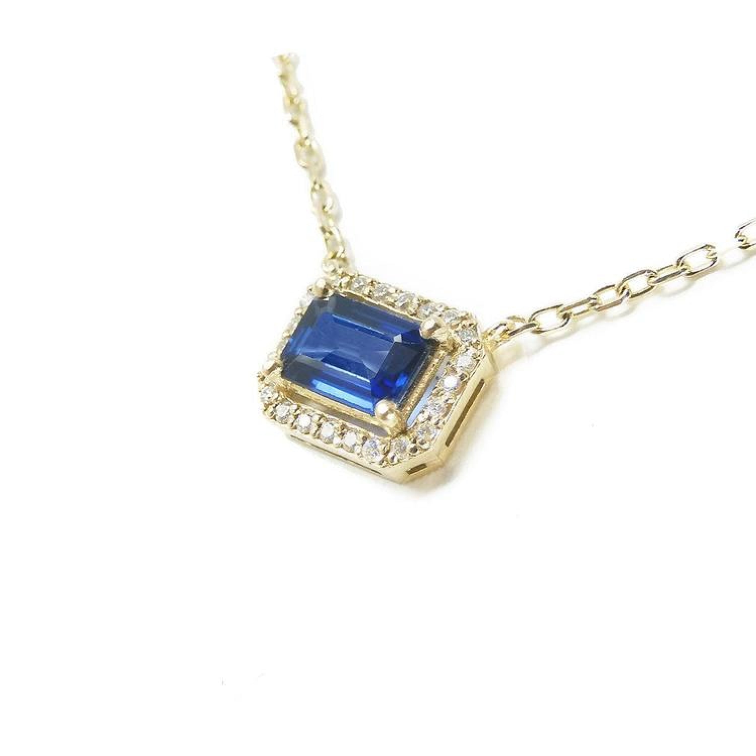 1.03 ct. emerald-cut blue sapphire necklace with diamond halo on a 14K yellow gold chain.