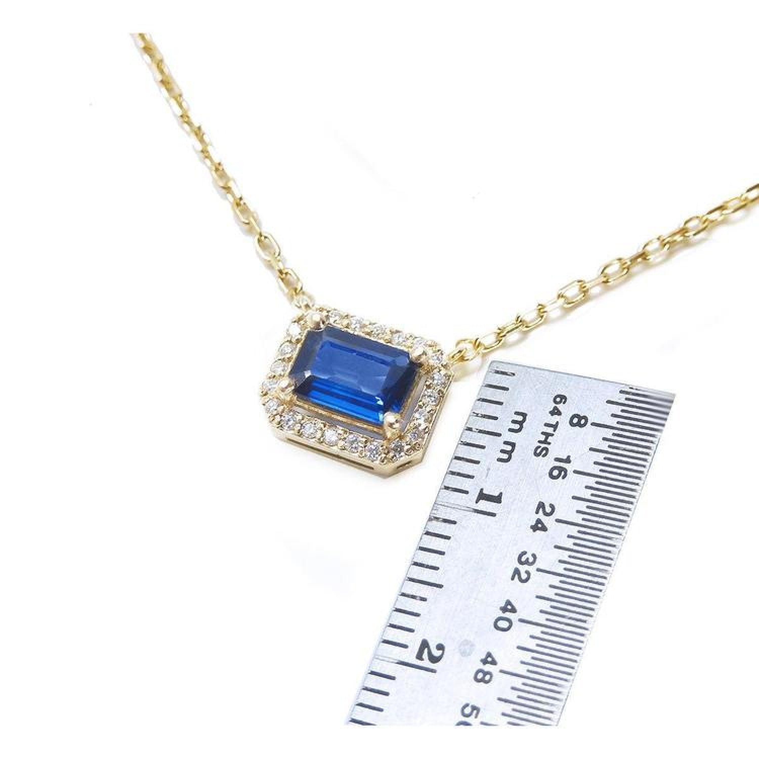 1.03 ct. natural blue sapphire necklace, emerald cut, east-west set in 14K yellow gold with diamond halo.