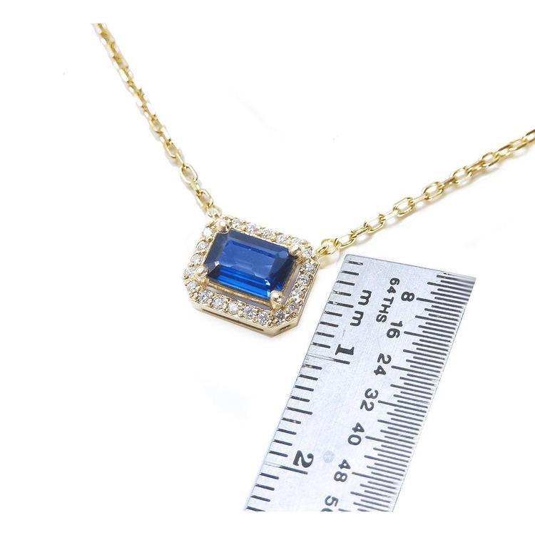 1.03 ct. natural blue sapphire necklace, emerald cut, east-west set in 14K yellow gold with diamond halo.