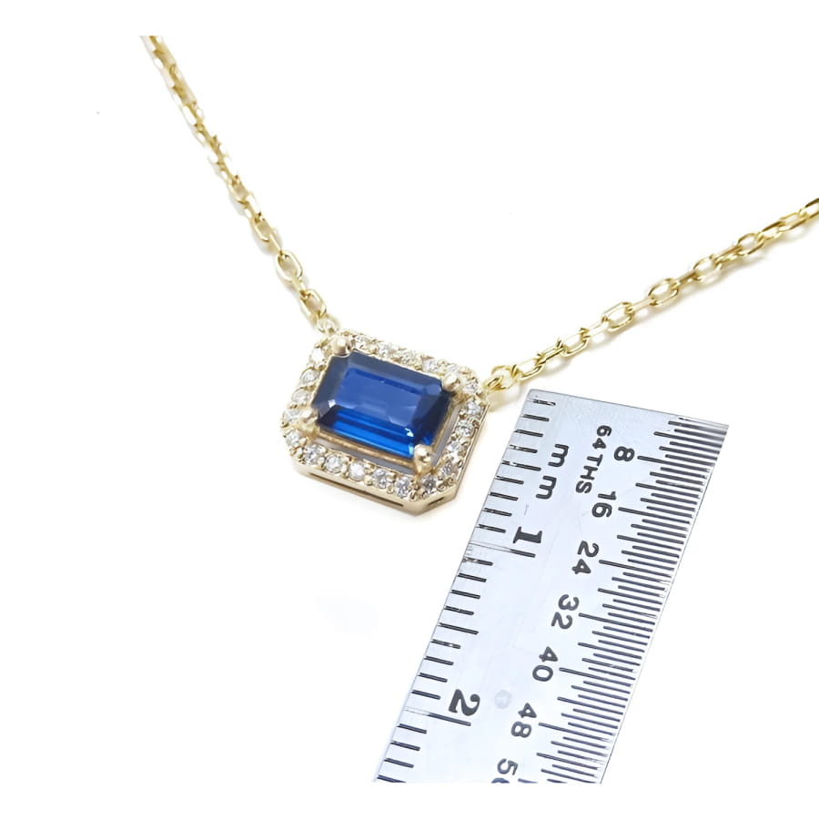 1.03 ct. natural blue sapphire necklace, emerald cut, east-west set in 14K yellow gold with diamond halo.