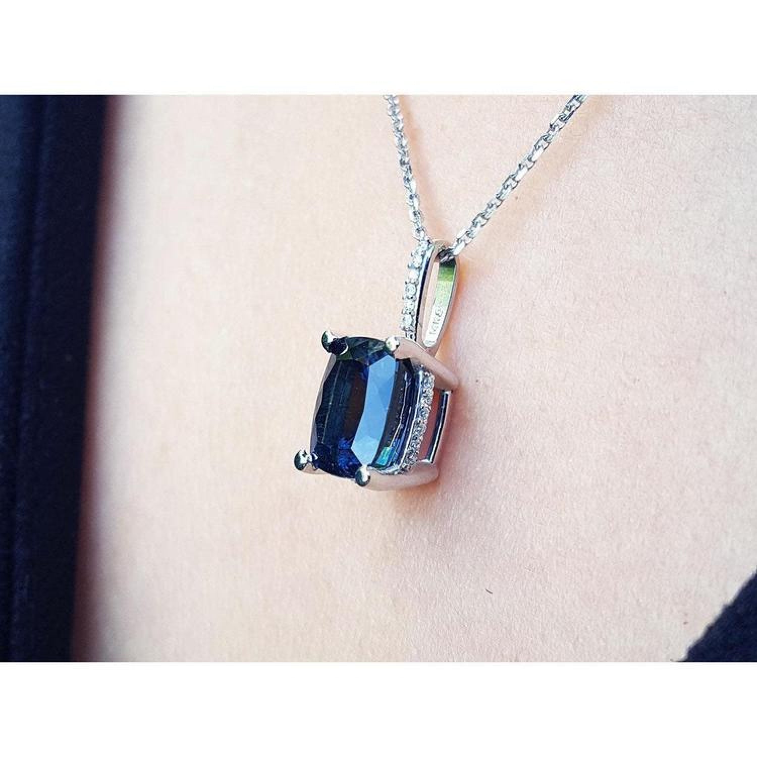 4.11 ct. cushion-cut deep blue sapphire solitaire pendant in 14K white gold on a chain.