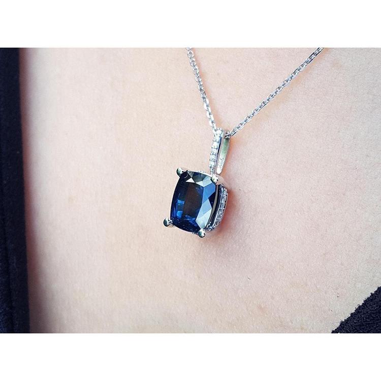 Blue sapphire gemstone necklace on a person's neck