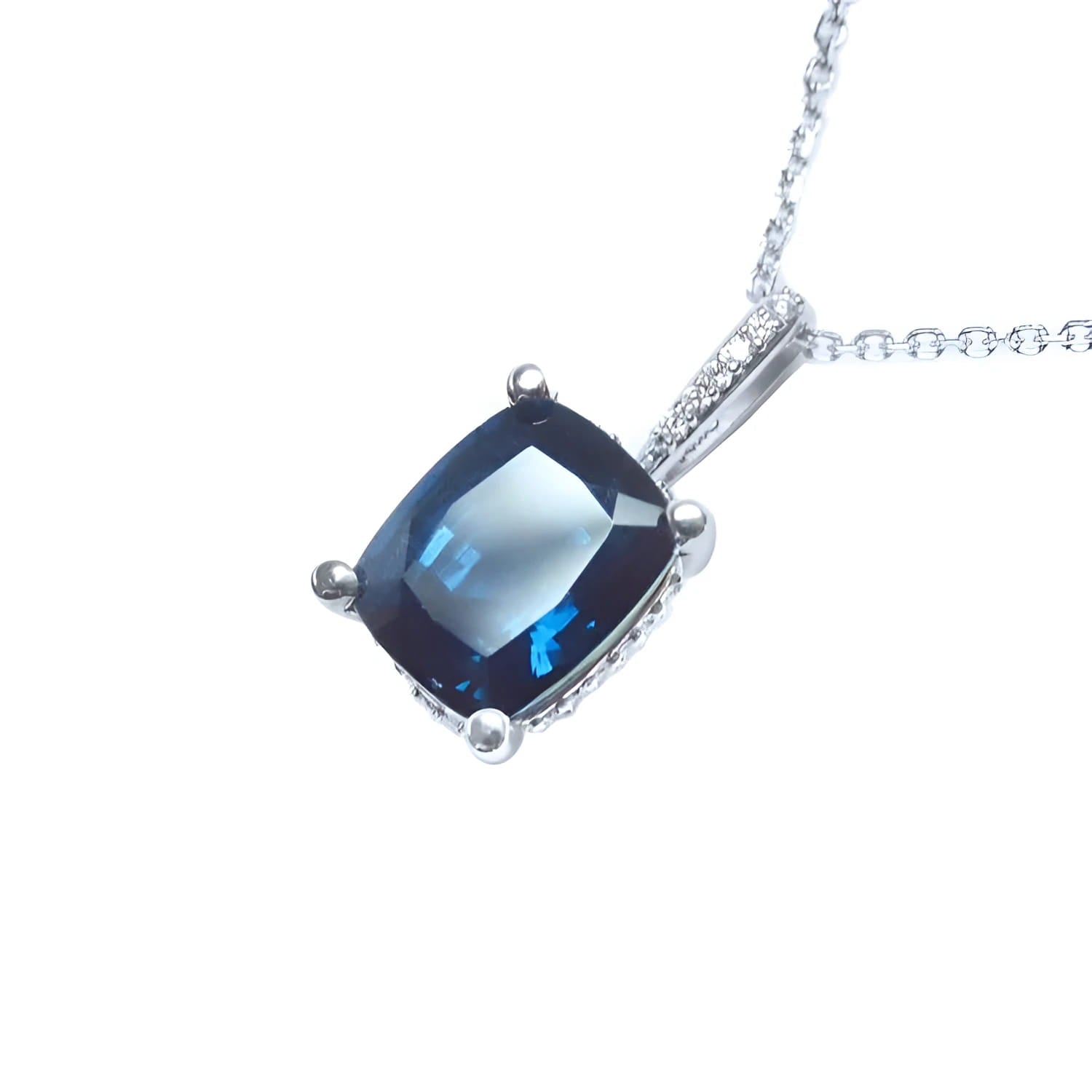 4.11 ct cushion cut deep blue sapphire solitaire pendant in 14K white gold with diamond accents.