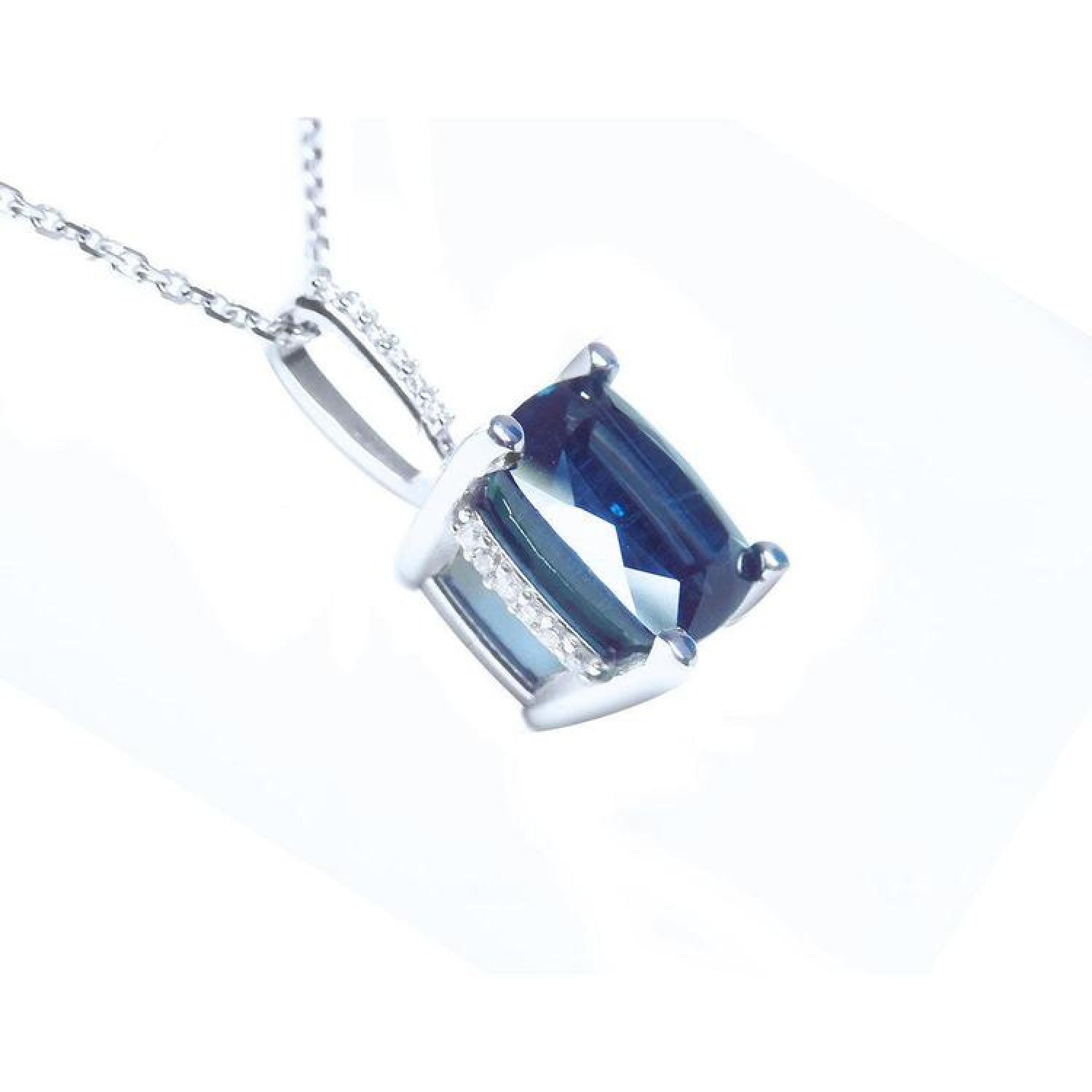 4.11 ct cushion cut deep blue sapphire solitaire pendant in 14K white gold with a four-prong setting.