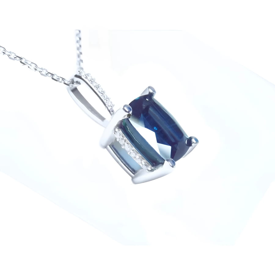 4.11 ct cushion cut deep blue sapphire solitaire pendant in 14K white gold with a four-prong setting.